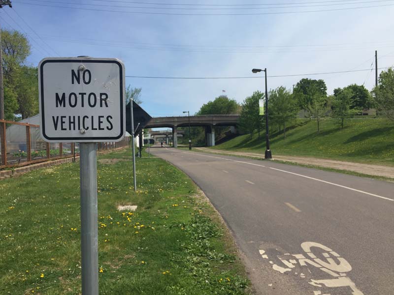 A greenway and a sign that says 'No Motor Vehicles'